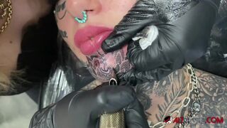 Gorgeous chick covered in tattoos gets another tattoo on her face